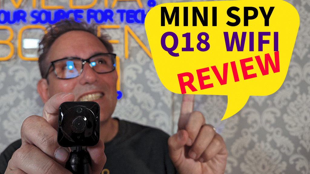Enthusiastic tech reviewer holding a Mini Spy Q18 WiFi camera for a video review, with a vibrant 'Mini Spy Q18 WiFi Review' graphic overlay