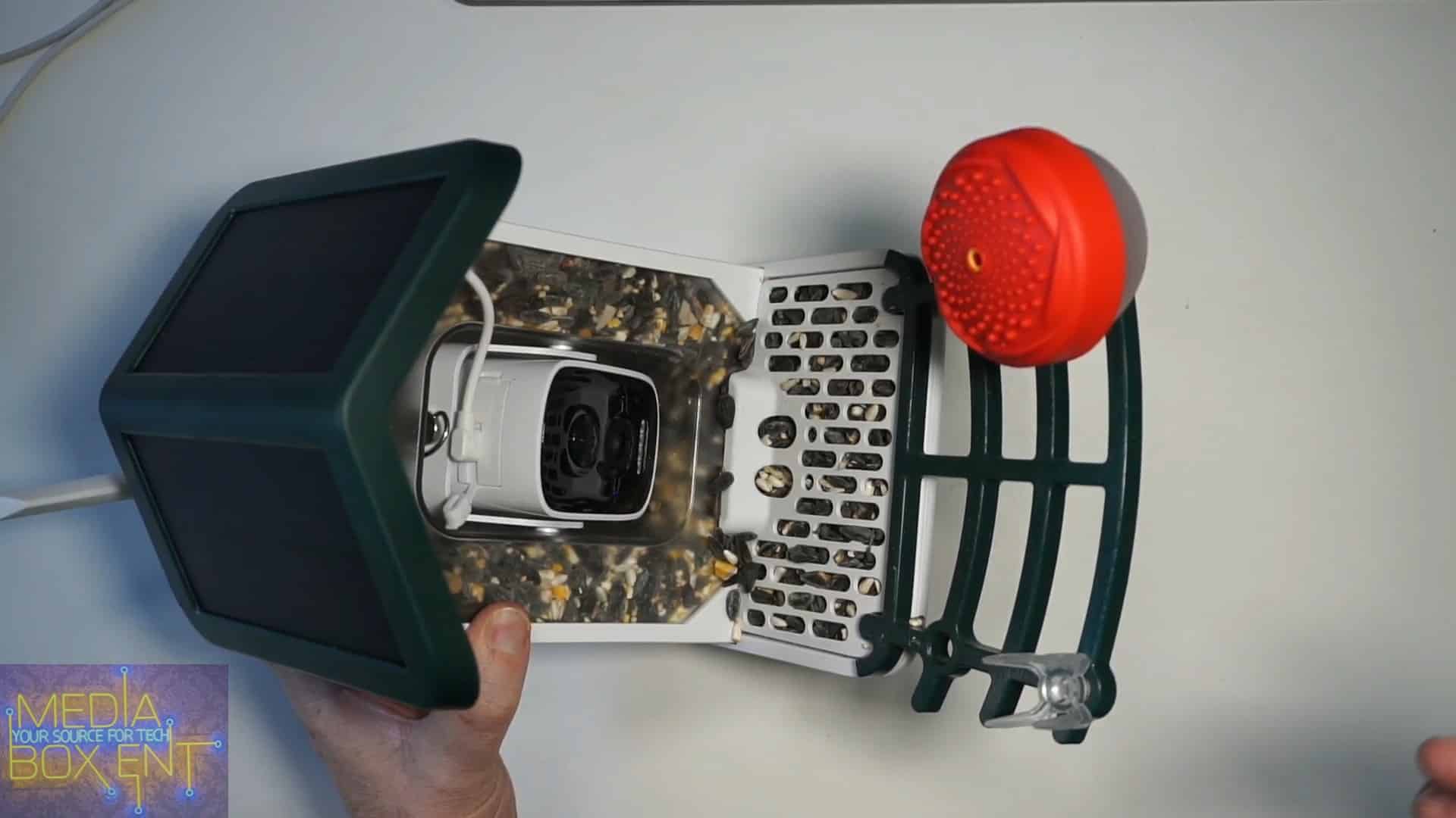 Solar-powered bird feeder with built-in camera and red microphone
